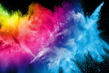 Abstract Multi Color Powder Explosion On Black Background.  Freeze Motion Of Color Dust  Particles Splash. Painted Holi In Festival.