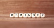 Word REMINDER made with wood building blocks