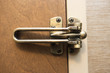 closed and locked brown wood door with latch