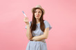 © ViDi Studio - Sad unhappy woman in blue dress, hat hold in hand, looking at pregnancy test isolated on pink background. Medical healthcare gynecological, pregnancy fertility maternity people concept. Copy space.