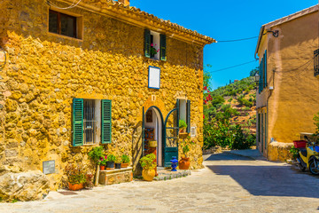 Wall Mural - a narrow street in the spanish town deia at mallorca