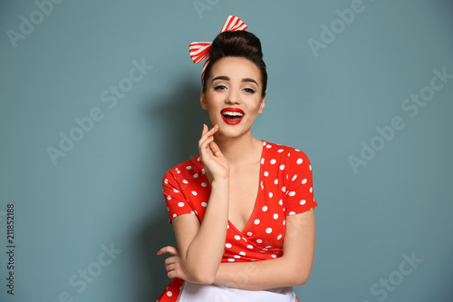 Photo  Portrait of funny young housewife on color background