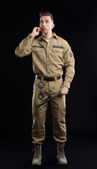 Wall Mural - Male security guard using portable radio transmitter on dark background