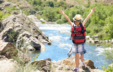 Poster - Little girl on rock near river. Summer camp