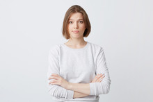 Unhappy Dissatisfied Young Woman In Longsleeve Standing With Hands Folded And Feels Disappointed Isolated Over White Background