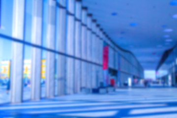 Poster - The building is long. Background for a business concept. The long hall. Panoramic windows. The sun shines through the high windows. Background.