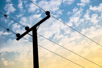 High voltage power pole on the blue sky and cloud close up.