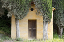 A Small Tuscan Chapel Surrounded By Cypress Trees Near Lucignano D'Asso, Tuscany