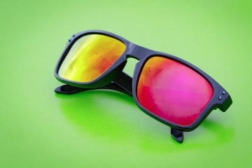 Image of modern fashionable sunglasses on green background, Glasses.