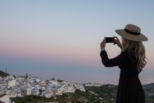 Traveler Taking A Picture With Her Smartphone In Small Spanish Village