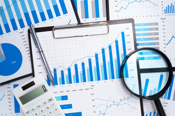 Poster - Data analysis. Developing business growth strategy. Many business reports. Magnifying glass,calculator and pen.
