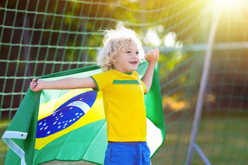 Wall Mural - Brazil football fan kids. Children play soccer.