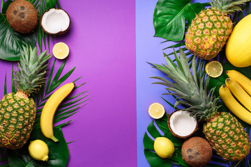  Exotic pineapples, coconuts, banana, melon, lemon, tropical palm and green monstera leaves on purple, violet background with copyspace. Creative layout. Monochrome summer concept. Flat lay, top view.