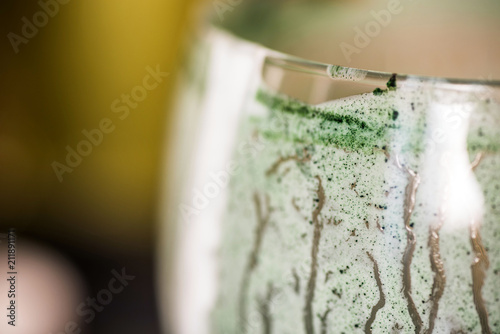 Closeup View Emptied Glass Of Fresh Kefir Probiotik Drink Mixed With Green Spirulina Powder On Kitchen Table Buy This Stock Photo And Explore Similar Images At Adobe Stock Adobe Stock