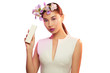 Close up isolated portrait of a young Asian lady with orchid flowers in her hair. The pretty girl posing on the white background, holding a box with cosmetic product. Blank label for branding mock-up.