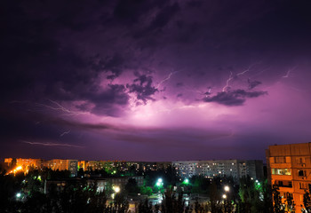 Lightning strikes down over the city at night. Beautiful shot. Long Exposure Photography