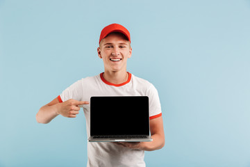 Canvas Print - Portrait of a smiling casual teenage boy in red cap