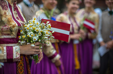 Wall Mural - Song and dance festival in Latvia. Procession in Riga. Elements of ornaments and flowers. Latvia 100 years.