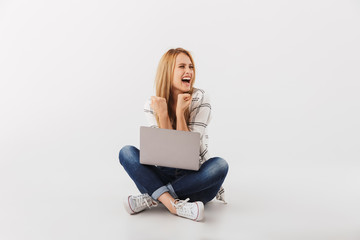 Portrait of happy young casual girl celebrating success