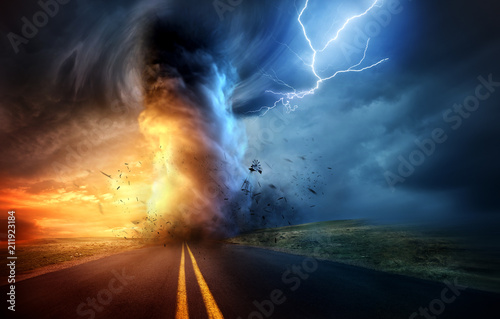 Fotomural A dramatic storm at sunset producing a powerful tornado twisting through the countryside with sheet lightning