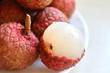 © ntramy - Fresh and juicy lychees on neutral background.