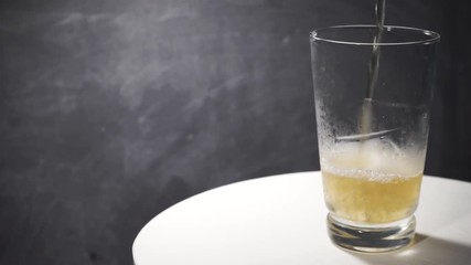 Aufkleber - Beer of glass on a white round table, rotation 360 degrees. Beautiful dark background.