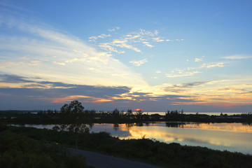 Wall Mural - orange sunset over river reflection in water landscape