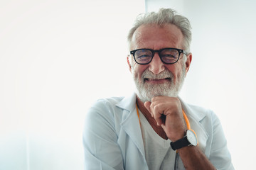 Portrait of senior doctor in examination room