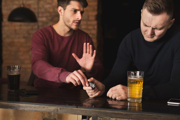 Drunk man taking car keys and his friend stopping him