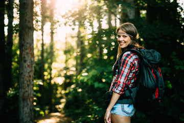 Wall Mural - female backpacker set out on forest trail