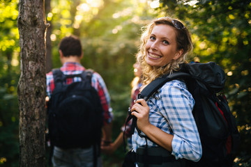 Wall Mural - couple trekking and hiking in forest