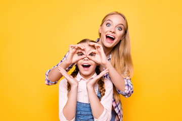 Joke positive emotion face facial expression adventure look health care concept. Portrait of two funky amazed shocked cute girls fooling around making eyeglasses with hands isolated bright background