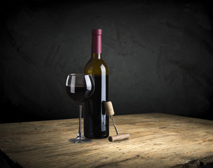 red wine bottle and wine glass on wodden barrel