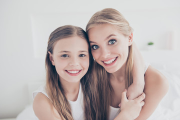 Poster - Close up portrait family photo of cute sweet lovely beautiful charming glad cheerful with toothy beaming smile mum and her pretty daughter embracing neck spending time together domestic life