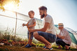 © ivanko80 - Young father with his son working in the garden