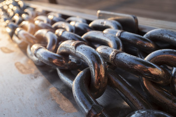 long metal chains on a boat dock near the water