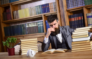 Leinwandbilder - Man or bearded teacher reads book. Research and studying concept.