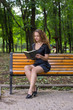 © Oleg Shapoval - A girl is reading in the park.