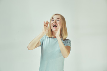 Wall Mural - Isolated on pink young casual woman shouting at studio