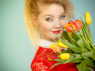 Pretty woman with red yellow tulips bunch