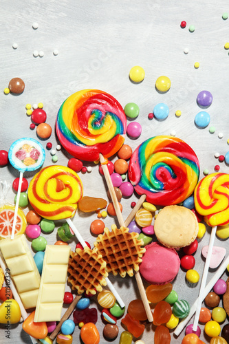 Plakat candies with jelly and sugar. colorful array of different childs sweets and treats