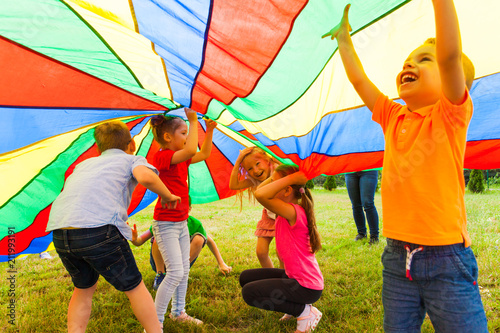 Fotomural Close up view of children under the huge rainbow cover