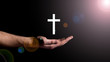 © yavyav - Male hand showing the cross, concept of the religion of Christianity