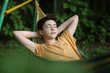© ulianna19970 - teenager boy resting sleep in hammock on summer green garden background