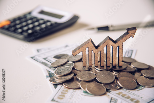 Fotografía Graph icons placed on coins-Concept of business goals.