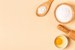 © tbralnina - Ingredients and utensils for baking on a pastel background.