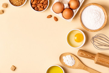 Ingredients and utensils for baking on a pastel background.