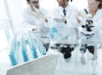 Wall Mural - background image of scientists studying blue liquid in a flask