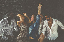 Group Of Friends Dancing In The Rain