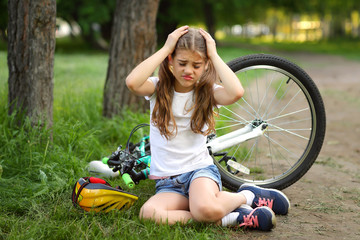 The girl was injured while riding a bike in the summer.